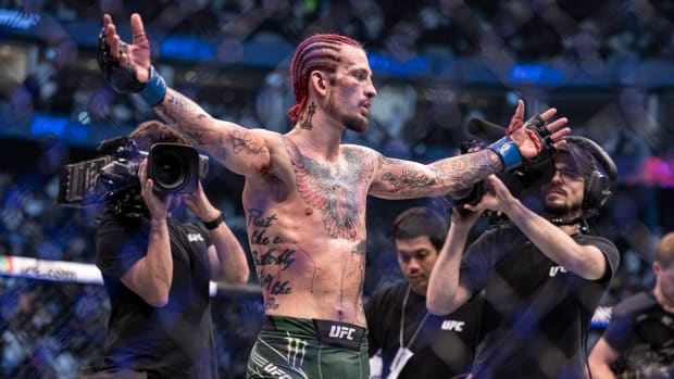 Sean O'Malley (blue gloves) defeats Petr Yan (red gloveS) during UFC 280 at Etihad Arena.